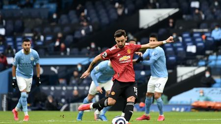 MANCHESTER, ENGLAND - MARCH 07: Bruno Fernandes of Manchester United scores their sides first goal from the penalty spot during the Premier League match between Manchester City and Manchester United at Etihad Stadium on March 07, 2021 in Manchester, England. Sporting stadiums around the UK remain under strict restrictions due to the Coronavirus Pandemic as Government social distancing laws prohibit fans inside venues resulting in games being played behind closed doors. (Photo by Peter Powell - Pool/Getty Images)