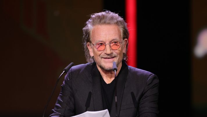 BERLIN, GERMANY - FEBRUARY 21: U2 singer and frontman Bono speaks on stage at the 'The Fabelmans' (Die Fabelmans) premiere & Honorary Golden Bear and homage for Steven Spielberg during the 73rd Berlinale International Film Festival Berlin at Berlinale Palast on February 21, 2023 in Berlin, Germany. (Photo by Andreas Rentz/Getty Images) bono u2