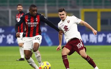  MILAN, ITALY - JANUARY 12: Amer Gojak of Torino F.C. is challenged by Pierre Kalulu of A.C. Milan during the Coppa Italia match between AC Milan and Torino FC at Stadio Giuseppe Meazza on January 12, 2021 in Milan, Italy. Sporting stadiums around Italy remain under strict restrictions due to the Coronavirus Pandemic as Government social distancing laws prohibit fans inside venues resulting in games being played behind closed doors. (Photo by Marco Luzzani/Getty Images)
