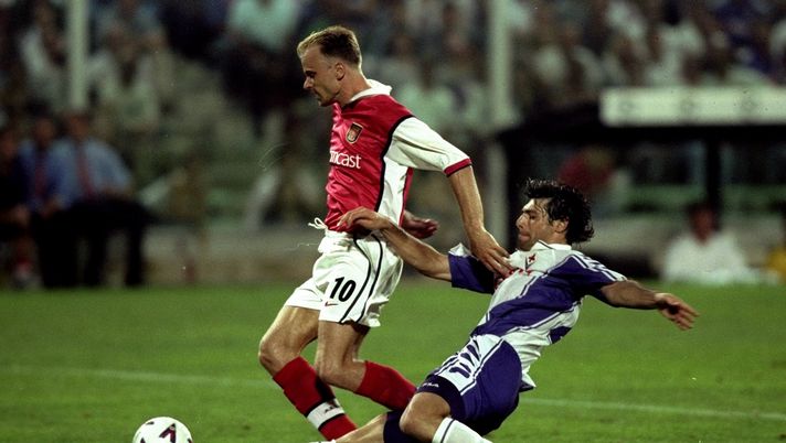 14 Sep 1999:  Dennis Bergkamp of Arsenal is challenged by Alessandro Pierini of Fiorentina during the UEFA Champions League group B match at the Stadio Communale in Florence, Italy. The game ended goalless.  Mandatory Credit: Gary M Prior/Allsport 