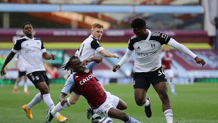 BIRMINGHAM, ENGLAND - APRIL 04: Bertrand Traore of Aston Villa goes down in a challenge from Ola Aina of Fulham during the Premier League match between Aston Villa and Fulham at Villa Park on April 04, 2021 in Birmingham, England. Sporting stadiums around the UK remain under strict restrictions due to the Coronavirus Pandemic as Government social distancing laws prohibit fans inside venues resulting in games being played behind closed doors. (Photo by Richard Heathcote/Getty Images) 