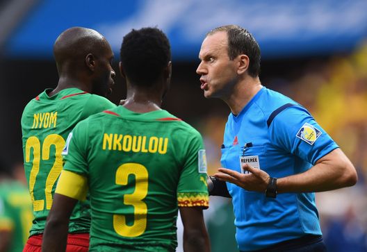 BRASILIA, BRAZIL - JUNE 23: Referee Jonas Eriksson speaks to Allan Nyom (L) and Nicolas N'Koulou of Cameroon during the 2014 FIFA World Cup Brazil Group A match between Cameroon and Brazil at Estadio Nacional on June 23, 2014 in Brasilia, Brazil.  (Photo by Stu Forster/Getty Images) 