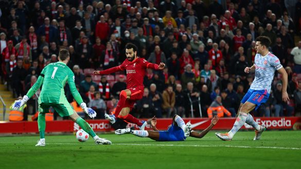 LIVERPOOL, ENGLAND - APRIL 19: Mohamed Salah of Liverpool has a shot on goal whilst under pressure from Aaron Wan-Bissaka and Harry Maguire of Manchester United during the Premier League match between Liverpool and Manchester United at Anfield on April 19, 2022 in Liverpool, England. (Photo by Clive Brunskill/Getty Images) LIVERPOOL, ENGLAND - APRIL 19: Mohamed Salah of Liverpool has a shot on goal whilst under pressure from Aaron Wan-Bissaka and Harry Maguire of Manchester United during the Premier League match between Liverpool and Manchester United at Anfield on April 19, 2022 in Liverpool, England. (Photo by Clive Brunskill/Getty Images)