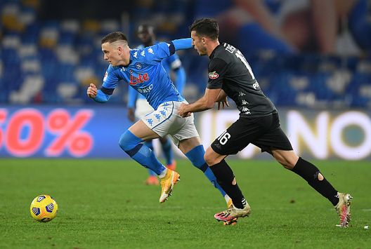 NAPLES, ITALY - JANUARY 13: Piotr Zielinski of Napoli breaks past Nicolo Casale of Empoli during the Coppa Italia match between SSC Napoli and Empoli FC at Stadio Diego Armando Maradona on January 13, 2021 in Naples, Italy. Sporting stadiums around Italy remain under strict restrictions due to the Coronavirus Pandemic as Government social distancing laws prohibit fans inside venues resulting in games being played behind closed doors. (Photo by Francesco Pecoraro/Getty Images) NAPLES, ITALY - JANUARY 13: Piotr Zielinski of Napoli breaks past Nicolo Casale of Empoli during the Coppa Italia match between SSC Napoli and Empoli FC at Stadio Diego Armando Maradona on January 13, 2021 in Naples, Italy. Sporting stadiums around Italy remain under strict restrictions due to the Coronavirus Pandemic as Government social distancing laws prohibit fans inside venues resulting in games being played behind closed doors. (Photo by Francesco Pecoraro/Getty Images)