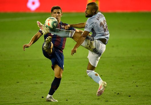  VIGO, SPAIN - JULY 16: Enis Bardhi of Levante tackles Rafinha of Celta Vigo during the Liga match between RC Celta de Vigo and Levante UD at Abanca-Balaídos on July 16, 2020 in Vigo, Spain. (Photo by Octavio Passos/Getty Images) 