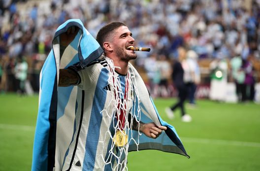 LUSAIL CITY, QATAR - DECEMBER 18: Rodrigo De Paul of Argentina celebrates with a cigar, Argentina flag and a cut piece of the net after the win during the FIFA World Cup Qatar 2022 Final match between Argentina and France at Lusail Stadium on December 18, 2022 in Lusail City, Qatar. (Photo by Clive Brunskill/Getty Images) De Paul