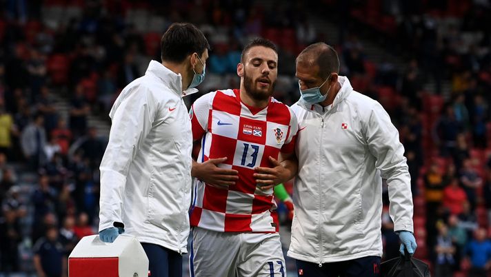 GLASGOW, SCOTLAND - JUNE 22: Nikola Vlasic of Croatia leaves the pitch after receiving medical treatment during the UEFA Euro 2020 Championship Group D match between Croatia and Scotland at Hampden Park on June 22, 2021 in Glasgow, Scotland. (Photo by Paul Ellis - Pool/Getty Images) 