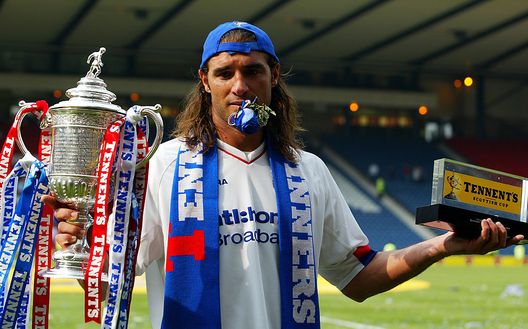 GLASGOW - MAY 31:  Winning goalscorer Lorenzo Amoruso of Rangers celebrates victory after the Tennant's Scottish Cup Final match between Dundee and Glasgow Rangers held on May 31, 2003 at Hampden Park, in Glasgow, Scotland. Glasgow Rangers won the match and cup 1-0. (Photo by Ben Radford/Getty Images) 