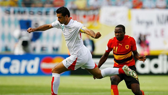 LEIPZIG, GERMANY - JUNE 21: Ali Daei of Iran skips past Mateus of Angola during the FIFA World Cup Germany 2006 Group D match between Iran and Angola played at the Zentralstadion on June 21, 2006 in Leipzig, Germany. (Photo by Shaun Botterill/Getty Images) LEIPZIG, GERMANY - JUNE 21: Ali Daei of Iran skips past Mateus of Angola during the FIFA World Cup Germany 2006 Group D match between Iran and Angola played at the Zentralstadion on June 21, 2006 in Leipzig, Germany. (Photo by Shaun Botterill/Getty Images)