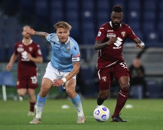 ROME, ITALY - MAY 18: Ciro Immobile of S.S. Lazio battles for possession with Nicolas Nkoulou of Torino FC during the Serie A match between SS Lazio and Torino FC at Stadio Olimpico on May 18, 2021 in Rome, Italy. Sporting stadiums around Italy remain under strict restrictions due to the Coronavirus Pandemic as Government social distancing laws prohibit fans inside venues resulting in games being played behind closed doors. (Photo by Paolo Bruno/Getty Images) ROME, ITALY - MAY 18: Ciro Immobile of S.S. Lazio battles for possession with Nicolas Nkoulou of Torino FC during the Serie A match between SS Lazio and Torino FC at Stadio Olimpico on May 18, 2021 in Rome, Italy. Sporting stadiums around Italy remain under strict restrictions due to the Coronavirus Pandemic as Government social distancing laws prohibit fans inside venues resulting in games being played behind closed doors. (Photo by Paolo Bruno/Getty Images)