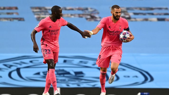 MANCHESTER, ENGLAND - AUGUST 07: Karim Benzema of Real Madrid celebrates with teammate Ferland Mendy after scoring his team's first goal during the UEFA Champions League round of 16 second leg match between Manchester City and Real Madrid at Etihad Stadium on August 07, 2020 in Manchester, England. (Photo by Shaun Botterill/Getty Images) MANCHESTER, ENGLAND - AUGUST 07: Karim Benzema of Real Madrid celebrates with teammate Ferland Mendy after scoring his team's first goal during the UEFA Champions League round of 16 second leg match between Manchester City and Real Madrid at Etihad Stadium on August 07, 2020 in Manchester, England. (Photo by Shaun Botterill/Getty Images)