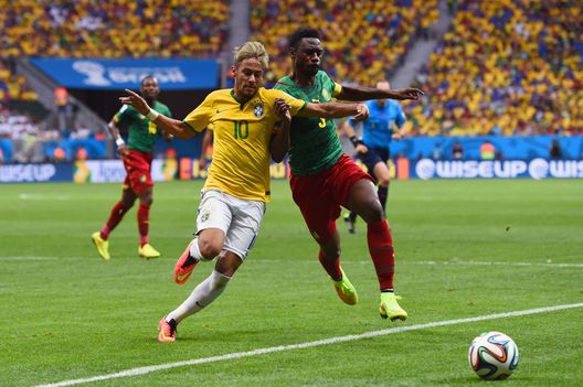  BRASILIA, BRAZIL - JUNE 23: Neymar of Brazil competes for the ball with Nicolas N'Koulou of Cameroon during the 2014 FIFA World Cup Brazil Group A match between Cameroon and Brazil at Estadio Nacional on June 23, 2014 in Brasilia, Brazil. (Photo by Stu Forster/Getty Images) 