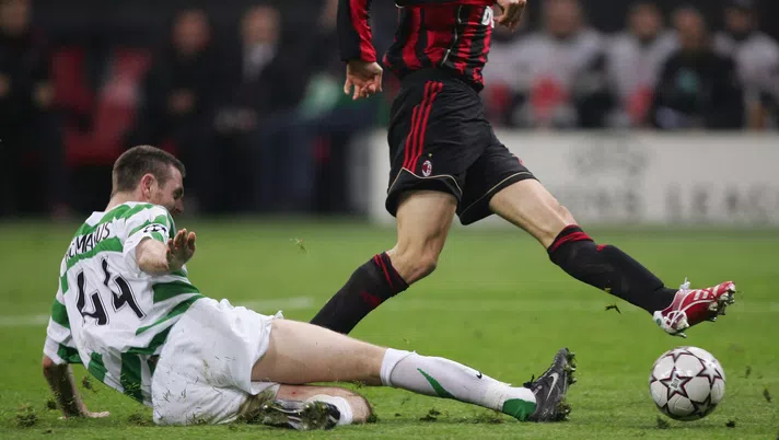 MILAN, ITALY - MARCH 07: Kaka of Milan scores the opening goal as Stephen McManus of Celtic slides in during the UEFA Champions League round of sixteen, second leg match between AC Milan and Celtic at the San Siro Stadium on March 7, 2007 in Milan, Italy. (Photo by Michael Steele/Getty Images)