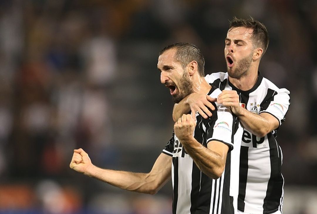  DOHA, QATAR - DECEMBER 23 : Giorgio Chiellini and Miralem Pjanic  of Juventus FC celebrates scoring a goal against AC Milan during the Supercoppa TIM Doha 2016 match between Juventus FC and AC Milan at the Jassim Bin Hamad Stadium on December 23, 2016 in Doha, Qatar. (Photo by AK BijuRaj/Getty Images) 