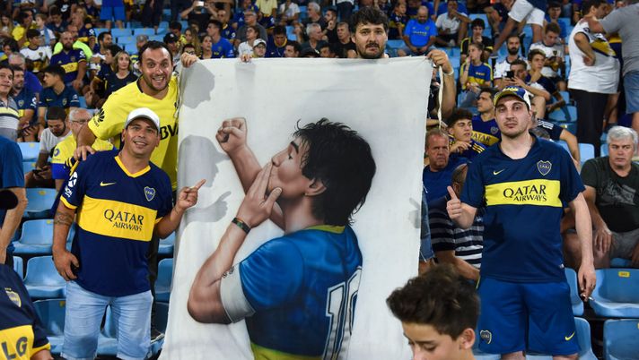 BUENOS AIRES, ARGENTINA - MARCH 07: Boca Juniors fans display a flag of Diego Maradona during a match between Boca Juniors and Gimnasia as part of Superliga 2019/20 at Estadio Alberto J. Armando on March 7, 2020 in Buenos Aires, Argentina. (Photo by Rodrigo Valle/Getty Images) BUENOS AIRES, ARGENTINA - MARCH 07: Boca Juniors fans display a flag of Diego Maradona during a match between Boca Juniors and Gimnasia as part of Superliga 2019/20 at Estadio Alberto J. Armando on March 7, 2020 in Buenos Aires, Argentina. (Photo by Rodrigo Valle/Getty Images)