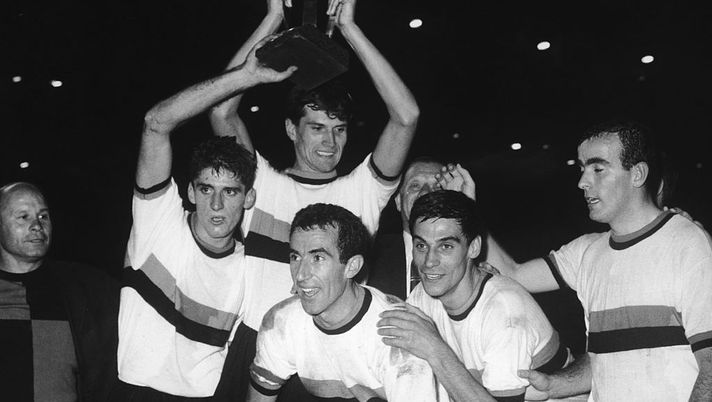 Armando Picchi, captain of the Internazionale or Inter football team, celebrates his team's win in the World Club Championship at the Santiago Bernabeu Stadium in Madrid, 26th September 1964. Holding the cup is teammate Giacinto Facchetti. (Photo by Hulton Archive/Getty Images) 