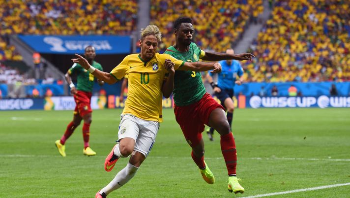BRASILIA, BRAZIL - JUNE 23: Neymar of Brazil competes for the ball with Nicolas N'Koulou of Cameroon during the 2014 FIFA World Cup Brazil Group A match between Cameroon and Brazil at Estadio Nacional on June 23, 2014 in Brasilia, Brazil.  (Photo by Stu Forster/Getty Images) 