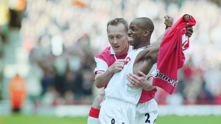 Ian Wright of Arsenal football club takes off his shirt and celebrates with team mate Lee Dixon after breaking Cliff Bastin's Arsenal goalscoring record of 178 goals with a hat-trick against Bolton Wanderers on13 September 1997 at the Arsenal Stadium, Highbury Stadium, London, United Kingdom. (Photo by Shaun Botterill/Getty Images). Ian Wright of Arsenal football club takes off his shirt and celebrates with team mate Lee Dixon after breaking Cliff Bastin's Arsenal goalscoring record of 178 goals with a hat-trick against Bolton Wanderers on13 September 1997 at the Arsenal Stadium, Highbury Stadium, London, United Kingdom. (Photo by Shaun Botterill/Getty Images).