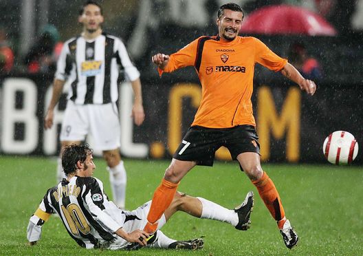 TORINO, ITALY - OCTOBER 28: Alessandro Del Piero of Juventus and Luigi Sartor of Roma in action during the Serie A match between Juventus and Roma at the Delle Alpi Stadium on October 28, 2004 in Torino, Italy. (Photo by New Press/Getty Images) TORINO, ITALY - OCTOBER 28: Alessandro Del Piero of Juventus and Luigi Sartor of Roma in action during the Serie A match between Juventus and Roma at the Delle Alpi Stadium on October 28, 2004 in Torino, Italy. (Photo by New Press/Getty Images)