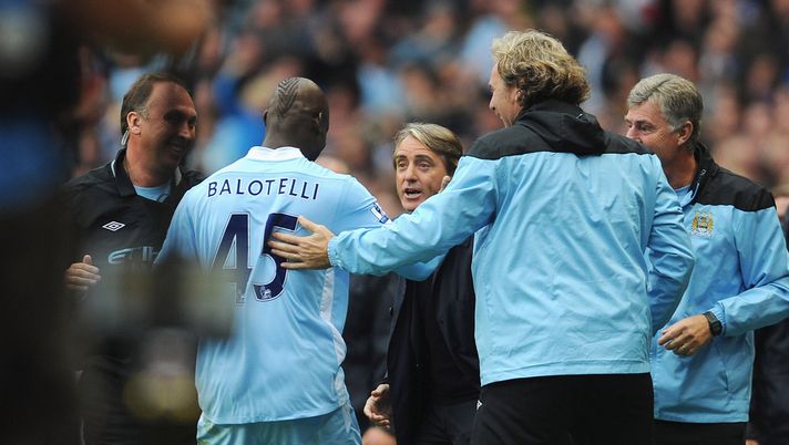 MANCHESTER, ENGLAND - SEPTEMBER 24:  Mario Balotelli of Manchester City celebrates scoring to make it 1-0 with manager Roberto Mancini during the Barclays Premier League match between Manchester City and Everton at the Etihad Stadium on September 24, 2011 in Manchester, England.  (Photo by Michael Regan/Getty Images) 