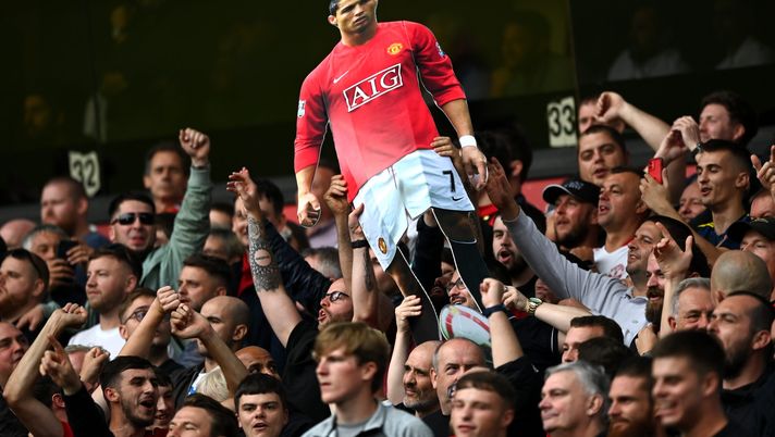 WOLVERHAMPTON, ENGLAND - AUGUST 29: Fans of Manchester United hold up a cardboard cutout of New Signing Cristiano Ronaldo during the Premier League match between Wolverhampton Wanderers and Manchester United at Molineux on August 29, 2021 in Wolverhampton, England. (Photo by Shaun Botterill/Getty Images) WOLVERHAMPTON, ENGLAND - AUGUST 29: Fans of Manchester United hold up a cardboard cutout of New Signing Cristiano Ronaldo during the Premier League match between Wolverhampton Wanderers and Manchester United at Molineux on August 29, 2021 in Wolverhampton, England. (Photo by Shaun Botterill/Getty Images)