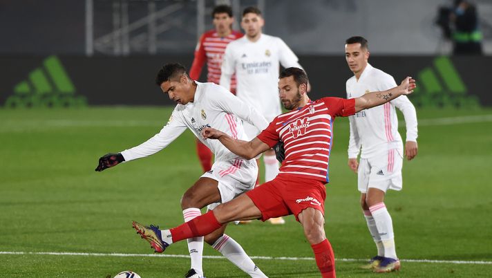 MADRID, SPAIN - DECEMBER 23: Raphael Varane of Real Madrid is challenged by Roberto Soldado of Granada CF during the La Liga Santander match between Real Madrid and Granada CF at Estadio Alfredo Di Stefano on December 23, 2020 in Madrid, Spain. Sporting stadiums around Spain remain under strict restrictions due to the Coronavirus Pandemic as Government social distancing laws prohibit fans inside venues resulting in games being played behind closed doors. (Photo by Denis Doyle/Getty Images) MADRID, SPAIN - DECEMBER 23: Raphael Varane of Real Madrid is challenged by Roberto Soldado of Granada CF during the La Liga Santander match between Real Madrid and Granada CF at Estadio Alfredo Di Stefano on December 23, 2020 in Madrid, Spain. Sporting stadiums around Spain remain under strict restrictions due to the Coronavirus Pandemic as Government social distancing laws prohibit fans inside venues resulting in games being played behind closed doors. (Photo by Denis Doyle/Getty Images)
