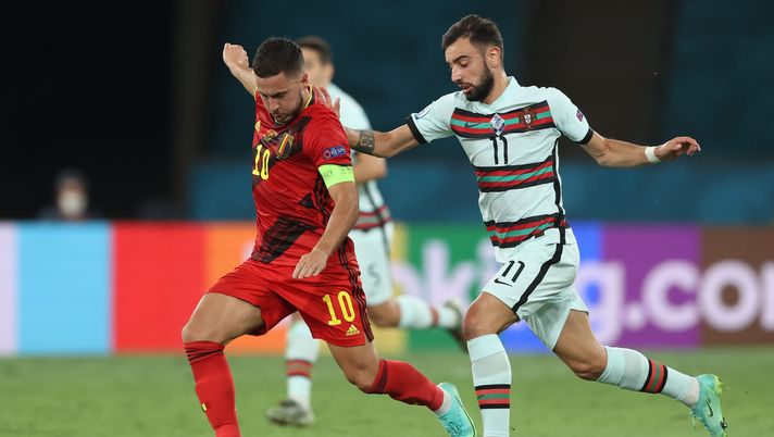 SEVILLE, SPAIN - JUNE 27: Eden Hazard of Belgium makes a pass as he is tackled by Bruno Fernandes of Portugal during the UEFA Euro 2020 Championship Round of 16 match between Belgium and Portugal at Estadio La Cartuja on June 27, 2021 in Seville, Spain. (Photo by Alexander Hassenstein/Getty Images) SEVILLE, SPAIN - JUNE 27: Eden Hazard of Belgium makes a pass as he is tackled by Bruno Fernandes of Portugal during the UEFA Euro 2020 Championship Round of 16 match between Belgium and Portugal at Estadio La Cartuja on June 27, 2021 in Seville, Spain. (Photo by Alexander Hassenstein/Getty Images)