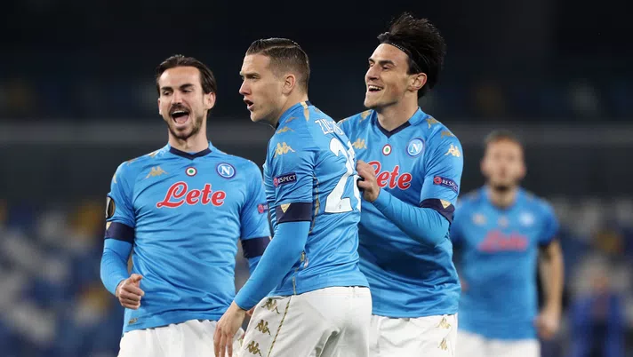NAPLES, ITALY - FEBRUARY 25: Piotr Zielinski of Napoli celebreates with Fabian and Eljif Elmas after he scores their team's first goal during the UEFA Europa League Round of 32 match between SSC Napoli and Granada CF at Stadio Diego Armando Maradona on February 25, 2021 in Naples, Italy. Sporting stadiums around Italy remain under strict restrictions due to the Coronavirus Pandemic as Government social distancing laws prohibit fans inside venues resulting in games being played behind closed doors. (Photo by Francesco Pecoraro/Getty Images)
