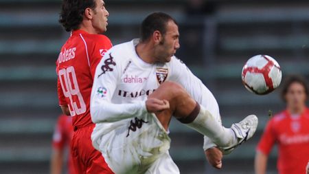 TRIESTE, ITALY - OCTOBER 31: Denis Godeas (L) of US Triestina Calcio competes with Simone Loria of Torino FC during the Serie B match US Triestina Calcio and Torino FC at Stadio Nereo Rocco on October 31, 2009 in Trieste, Italy. (Photo by Dino Panato/Getty Images)