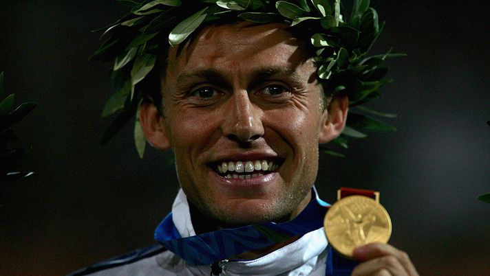 ATHENS - AUGUST 29: Gold medalist Stefano Baldini of Italy celebrates on the podium during the medal ceremony of the men's marathon on August 29, 2004 during the Athens 2004 Summer Olympic Games at the Olympic Stadium in the Sports Complex in Athens, Greece. Mebrahtom Keflezighi of USA came second and Vanderlei Lima of Brazil came third. (Photo by Scott Barbour/Getty Images) ATHENS - AUGUST 29: Gold medalist Stefano Baldini of Italy celebrates on the podium during the medal ceremony of the men's marathon on August 29, 2004 during the Athens 2004 Summer Olympic Games at the Olympic Stadium in the Sports Complex in Athens, Greece. Mebrahtom Keflezighi of USA came second and Vanderlei Lima of Brazil came third. (Photo by Scott Barbour/Getty Images)