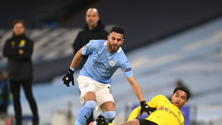 MANCHESTER, ENGLAND - APRIL 06: Riyad Mahrez of Manchester City battles for possession with Jude Bellingham of Borussia Dortmund during the UEFA Champions League Quarter Final match between Manchester City and Borussia Dortmund at Etihad Stadium on April 06, 2021 in Manchester, England. Sporting stadiums around the UK remain under strict restrictions due to the Coronavirus Pandemic as Government social distancing laws prohibit fans inside venues resulting in games being played behind closed doors. (Photo by Michael Regan/Getty Images) MANCHESTER, ENGLAND - APRIL 06: Riyad Mahrez of Manchester City battles for possession with Jude Bellingham of Borussia Dortmund during the UEFA Champions League Quarter Final match between Manchester City and Borussia Dortmund at Etihad Stadium on April 06, 2021 in Manchester, England. Sporting stadiums around the UK remain under strict restrictions due to the Coronavirus Pandemic as Government social distancing laws prohibit fans inside venues resulting in games being played behind closed doors. (Photo by Michael Regan/Getty Images)