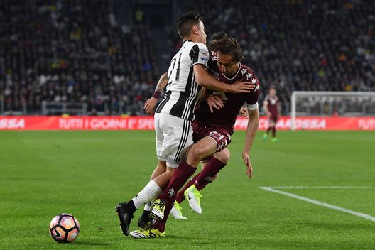  TURIN, ITALY - MAY 06: Paulo Dybala (L) of Juventus FC clashes with Emiliano Moretti of FC Torino during the Serie A match between Juventus FC and FC Torino at Juventus Stadium on May 6, 2017 in Turin, Italy. (Photo by Valerio Pennicino/Getty Images) 