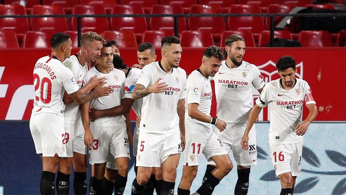 SEVILLE, SPAIN - JULY 19: Sergio Reguilon of Sevilla FC celebrates with teammates after scoring his sides first goal during the Liga match between Sevilla FC and Valencia CF at Estadio Ramon Sanchez Pizjuan on July 19, 2020 in Seville, Spain. Football Stadiums around Europe remain empty due to the Coronavirus Pandemic as Government social distancing laws prohibit fans inside venues resulting in all fixtures being played behind closed doors. (Photo by Fran Santiago/Getty Images) SEVILLE, SPAIN - JULY 19: Sergio Reguilon of Sevilla FC celebrates with teammates after scoring his sides first goal during the Liga match between Sevilla FC and Valencia CF at Estadio Ramon Sanchez Pizjuan on July 19, 2020 in Seville, Spain. Football Stadiums around Europe remain empty due to the Coronavirus Pandemic as Government social distancing laws prohibit fans inside venues resulting in all fixtures being played behind closed doors. (Photo by Fran Santiago/Getty Images)