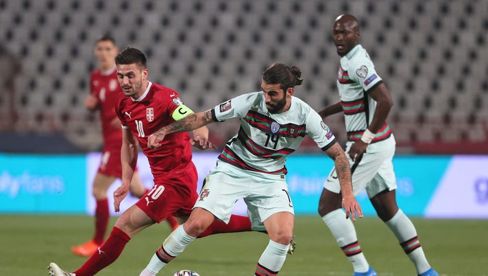 BELGRADE, SERBIA - MARCH 27: Sergio Oliveira of Portugal and Dusan Tadic of Serbia  battle for the ball  during the FIFA World Cup 2022 Qatar qualifying match between Serbia and Portugal at FK Crvena Zvezda stadium on March 27, 2021 in Belgrade, Serbia. Sporting stadiums around Serbia remain under strict restrictions due to the Coronavirus Pandemic as Government social distancing laws prohibit fans inside venues resulting in games being played behind closed doors.  (Photo by Srdjan Stevanovic/Getty Images) 