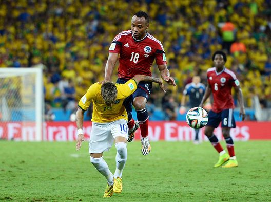 FORTALEZA, BRAZIL - JULY 04: Neymar of Brazil is challenged by Juan Camilo Zuniga of Colombia during the 2014 FIFA World Cup Brazil Quarter Final match between Brazil and Colombia at Castelao on July 4, 2014 in Fortaleza, Brazil. This tackle resulted in injury to Neymar and ended the player's World Cup. (Photo by Jamie McDonald/Getty Images) FORTALEZA, BRAZIL - JULY 04: Neymar of Brazil is challenged by Juan Camilo Zuniga of Colombia during the 2014 FIFA World Cup Brazil Quarter Final match between Brazil and Colombia at Castelao on July 4, 2014 in Fortaleza, Brazil. This tackle resulted in injury to Neymar and ended the player's World Cup. (Photo by Jamie McDonald/Getty Images)