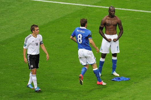 WARSAW, POLAND - JUNE 28: Mario Balotelli (R) of Italy celebrates with team-mate Claudio Marchisio after scoring his team's second goal as Philipp Lahm of Germany shows his dejection during the UEFA EURO 2012 semi final match between Germany and Italy at the National Stadium on June 28, 2012 in Warsaw, Poland. (Photo by Michael Regan/Getty Images) WARSAW, POLAND - JUNE 28: Mario Balotelli (R) of Italy celebrates with team-mate Claudio Marchisio after scoring his team's second goal as Philipp Lahm of Germany shows his dejection during the UEFA EURO 2012 semi final match between Germany and Italy at the National Stadium on June 28, 2012 in Warsaw, Poland. (Photo by Michael Regan/Getty Images)