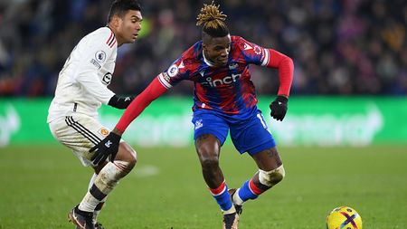 LONDON, ENGLAND - JANUARY 18: Wilfried Zaha of Crystal Palace takes on Casemiro of Manchester United during the Premier League match between Crystal Palace and Manchester United at Selhurst Park on January 18, 2023 in London, England. (Photo by Justin Setterfield/Getty Images)