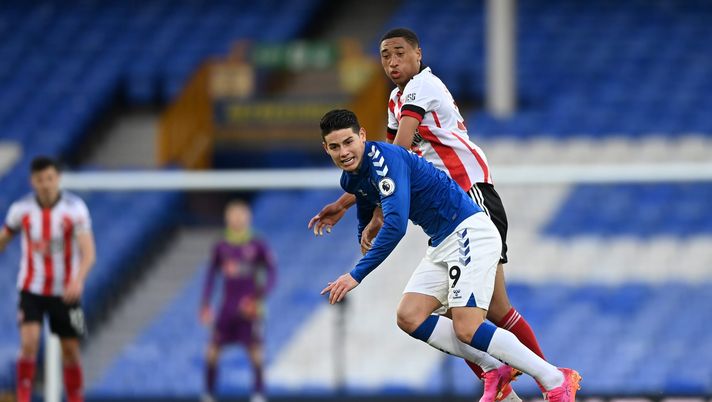 LIVERPOOL, ENGLAND - MAY 16: James Rodriguez of Everton battles for possession with Daniel Jebbison of Sheffield United during the Premier League match between Everton and Sheffield United at Goodison Park on May 16, 2021 in Liverpool, England. Sporting stadiums around the UK remain under strict restrictions due to the Coronavirus Pandemic as Government social distancing laws prohibit fans inside venues resulting in games being played behind closed doors. (Photo by Gareth Copley/Getty Images) LIVERPOOL, ENGLAND - MAY 16: James Rodriguez of Everton battles for possession with Daniel Jebbison of Sheffield United during the Premier League match between Everton and Sheffield United at Goodison Park on May 16, 2021 in Liverpool, England. Sporting stadiums around the UK remain under strict restrictions due to the Coronavirus Pandemic as Government social distancing laws prohibit fans inside venues resulting in games being played behind closed doors. (Photo by Gareth Copley/Getty Images)