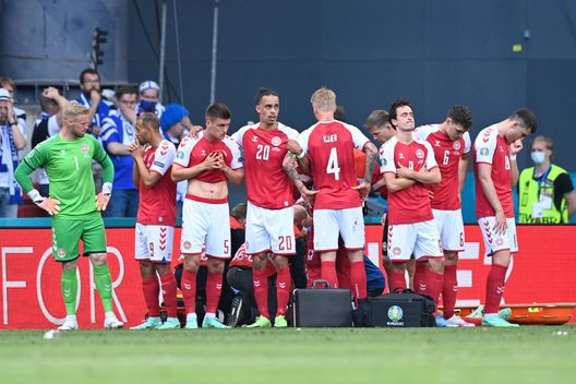 COPENHAGEN, DENMARK - JUNE 12: Joakim Maehle, Yussuf Poulsen, Simon Kjaer and Thomas Delaney of Denmark look dejected as team mate Christian Eriksen (hidden) receives medical treatment during the UEFA Euro 2020 Championship Group B match between Denmark and Finland on June 12, 2021 in Copenhagen, Denmark. (Photo by Stuart Franklin/Getty Images) COPENHAGEN, DENMARK - JUNE 12: Joakim Maehle, Yussuf Poulsen, Simon Kjaer and Thomas Delaney of Denmark look dejected as team mate Christian Eriksen (hidden) receives medical treatment during the UEFA Euro 2020 Championship Group B match between Denmark and Finland on June 12, 2021 in Copenhagen, Denmark. (Photo by Stuart Franklin/Getty Images)