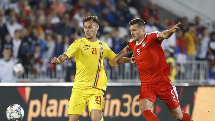 BELGRADE, SERBIA - SEPTEMBER 10: Denis Dragus (L) of Romania in action against Uros Spajic (R) of Serbia during the UEFA Nations League C group four match between Serbia and Romania at stadium Partizan on September 10, 2018 in Belgrade, Serbia. (Photo by Srdjan Stevanovic/Getty Images) BELGRADE, SERBIA - SEPTEMBER 10: Denis Dragus (L) of Romania in action against Uros Spajic (R) of Serbia during the UEFA Nations League C group four match between Serbia and Romania at stadium Partizan on September 10, 2018 in Belgrade, Serbia. (Photo by Srdjan Stevanovic/Getty Images)