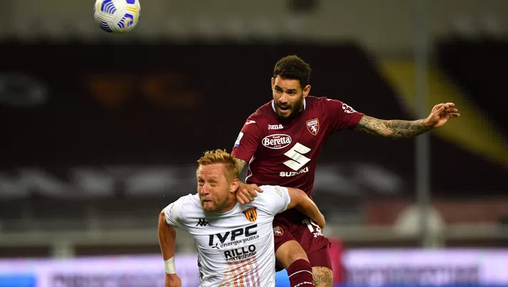 TURIN, ITALY - MAY 23: Antonio Sanabria of Torino F.C. battling for the header with Kamil Glik of Benevento Calcio  during the Serie A match between Torino FC v Benevento Calcio at Olimpico Stadium on May 23, 2021 in Turin, Italy. Sporting stadiums around Italy remain under strict restrictions due to the Coronavirus Pandemic as Government social distancing laws prohibit fans inside venues resulting in games being played behind closed doors.  (Photo by Valerio Pennicino/Getty Images)