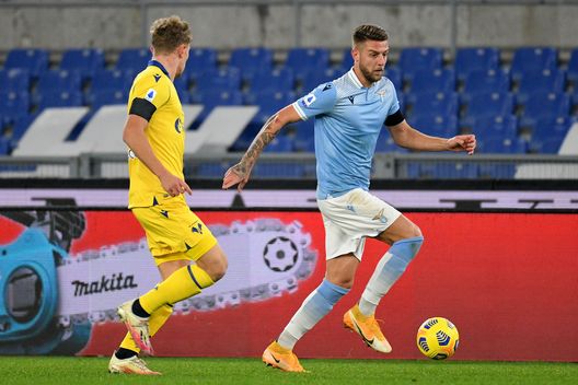 ROME, ITALY - DECEMBER 12: Sergej Milinkovic Savic of SS Lazio compete for the ball with Matteo Lovato of Hellas Verona FC during the Serie A match between SS Lazio and Hellas Verona FC at Stadio Olimpico on December 12, 2020 in Rome, Italy. (Photo by Marco Rosi - SS Lazio/Getty Images) ROME, ITALY - DECEMBER 12: Sergej Milinkovic Savic of SS Lazio compete for the ball with Matteo Lovato of Hellas Verona FC during the Serie A match between SS Lazio and Hellas Verona FC at Stadio Olimpico on December 12, 2020 in Rome, Italy. (Photo by Marco Rosi - SS Lazio/Getty Images)