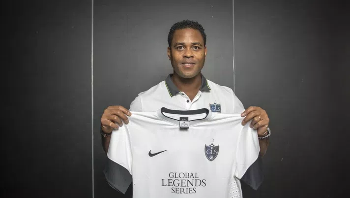 KUALA LUMPUR, MALAYSIA - OCTOBER 27:  Patrick Kluivert poses with a t-shirt at a Global Legends Series media event on October 27, 2014 in Kuala Lumpur, Malaysia. (Photo by Charles Pertwee/Getty Images for GLS)