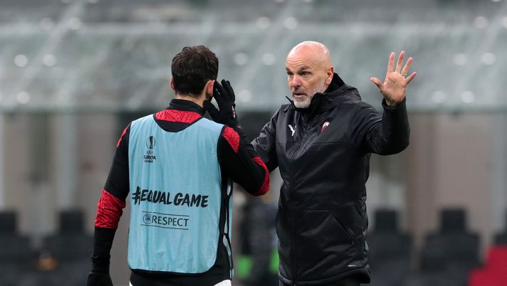MILAN, ITALY - DECEMBER 03: Stefano Pioli, Head Coach of A.C. Milan talks to Hakan Calhanoglu of A.C. Milan prior to the UEFA Europa League Group H stage match between AC Milan and Celtic at San Siro Stadium on December 03, 2020 in Milan, Italy. Sporting stadiums around Italy remain under strict restrictions due to the Coronavirus Pandemic as Government social distancing laws prohibit fans inside venues resulting in games being played behind closed doors. (Photo by Emilio Andreoli/Getty Images) MILAN, ITALY - DECEMBER 03: Stefano Pioli, Head Coach of A.C. Milan talks to Hakan Calhanoglu of A.C. Milan prior to the UEFA Europa League Group H stage match between AC Milan and Celtic at San Siro Stadium on December 03, 2020 in Milan, Italy. Sporting stadiums around Italy remain under strict restrictions due to the Coronavirus Pandemic as Government social distancing laws prohibit fans inside venues resulting in games being played behind closed doors. (Photo by Emilio Andreoli/Getty Images)