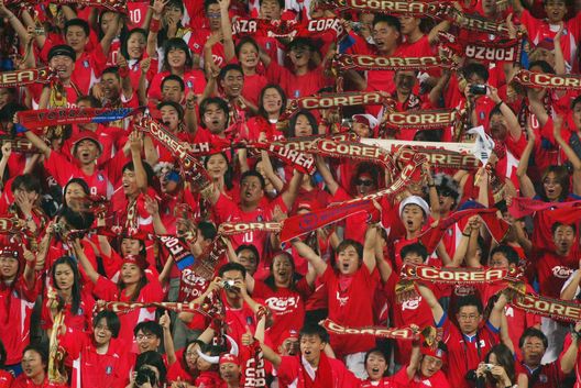 DAEJEON - JUNE 18: South Korea fans celebrate their teams 2-1 victory after the FIFA World Cup Finals 2002 Second Round match between South Korea and Italy played at the Daejeon World Cup Stadium, in Daejeon, South Korea on June 18, 2002. South Korea won the match 2-1 with a Golden Goal in extra-time. DIGITAL IMAGE. (Photo by Ben Radford/Getty Images) DAEJEON - JUNE 18: South Korea fans celebrate their teams 2-1 victory after the FIFA World Cup Finals 2002 Second Round match between South Korea and Italy played at the Daejeon World Cup Stadium, in Daejeon, South Korea on June 18, 2002. South Korea won the match 2-1 with a Golden Goal in extra-time. DIGITAL IMAGE. (Photo by Ben Radford/Getty Images)