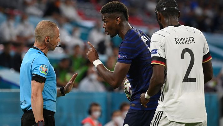 MUNICH, GERMANY - JUNE 15: Paul Pogba of France interacts with Assistant Referee, Juan Carlos Yuste after a challenge with Antonio Ruediger of Germany during the UEFA Euro 2020 Championship Group F match between France and Germany at Football Arena Munich on June 15, 2021 in Munich, Germany. (Photo by Matthias Hangst/Getty Images) MUNICH, GERMANY - JUNE 15: Paul Pogba of France interacts with Assistant Referee, Juan Carlos Yuste after a challenge with Antonio Ruediger of Germany during the UEFA Euro 2020 Championship Group F match between France and Germany at Football Arena Munich on June 15, 2021 in Munich, Germany. (Photo by Matthias Hangst/Getty Images)