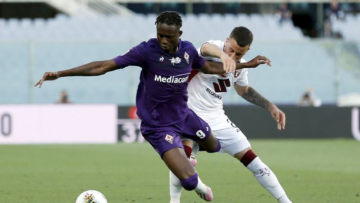 FLORENCE, ITALY - JULY 19: Christian Kouame of ACF Fiorentina battles for the ball with Alejandro Berenguer of Torino FC during the Serie A match between ACF Fiorentina and  Torino FC at Stadio Artemio Franchi on July 19, 2020 in Florence, Italy.  (Photo by Gabriele Maltinti/Getty Images) 