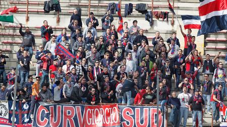 REGGIO CALABRIA, ITALY - MARCH 15: Fans of Crotone cheer during the Serie B match between Reggina Calcio and FC Crotone at Stadio Oreste Granillo on March 15, 2014 in Reggio Calabria, Italy. (Photo by Maurizio Lagana/Getty Images)