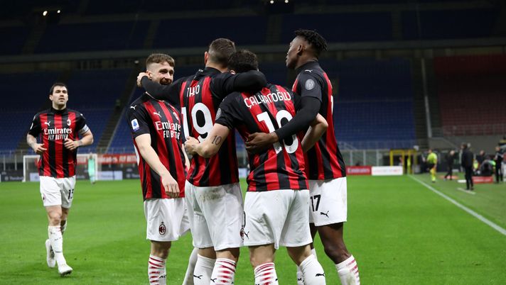MILAN, ITALY - MAY 01: Hakan Calhanoglu of A.C. Milan celebrates with Theo Hernandez and Rafael Leao after scoring their side's first goal during the Serie A match between AC Milan and Benevento Calcio at Stadio Giuseppe Meazza on May 01, 2021 in Milan, Italy. Sporting stadiums around Italy remain under strict restrictions due to the Coronavirus Pandemic as Government social distancing laws prohibit fans inside venues resulting in games being played behind closed doors.  (Photo by Marco Luzzani/Getty Images) 