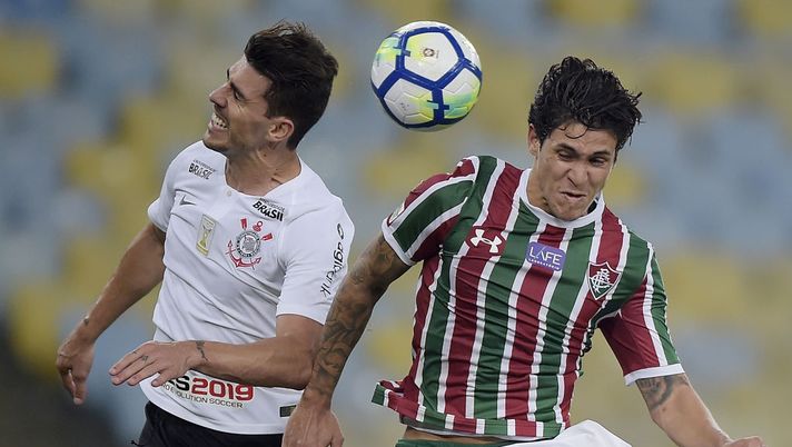 Pedro (R) of Fluminense struggles for the ball with Pedro Henrique of Corinthians  